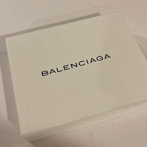 Balenciaga triple leather wrap bracelet in black and gold.